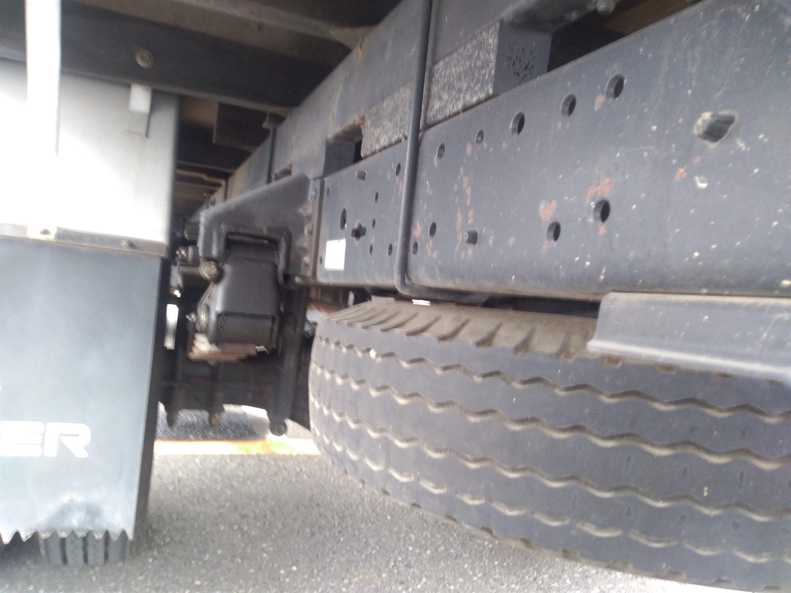 Truck chassis and rear tyre checked from below