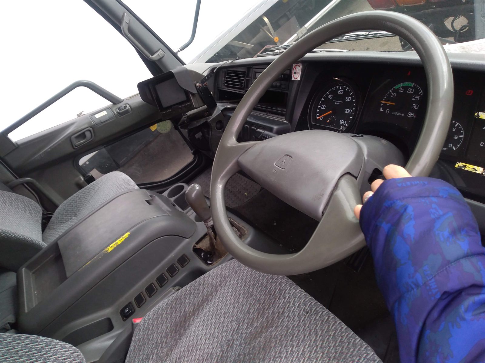 Driver's seat and controls being checked in a Japanese used truck