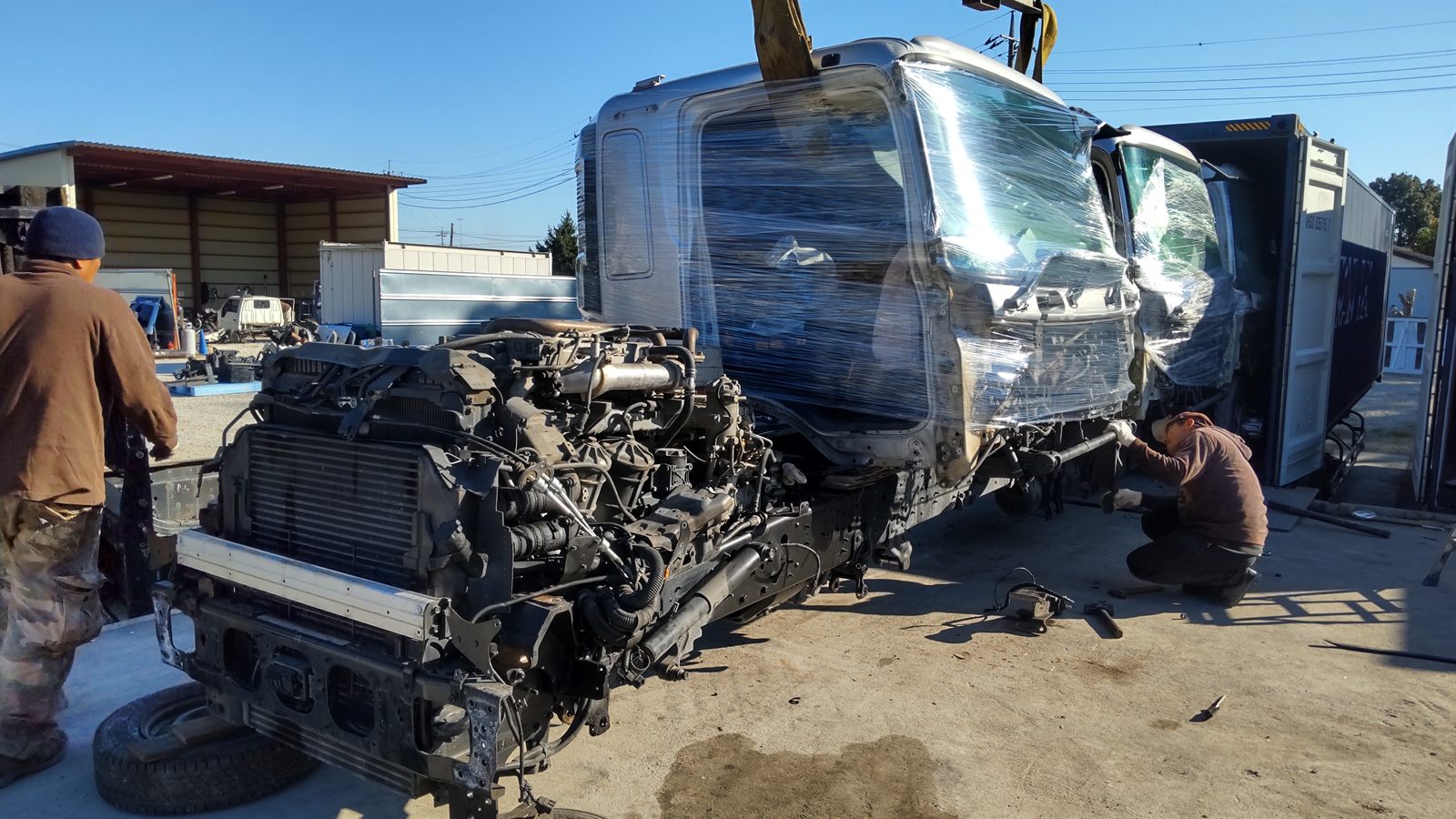 Specialists working on a truck chassis in Japan